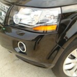 Before and after photographs of a damaged, black, Range Rover that was repaired by Elite Paint & Body Shop in West Palm Beach, FL.